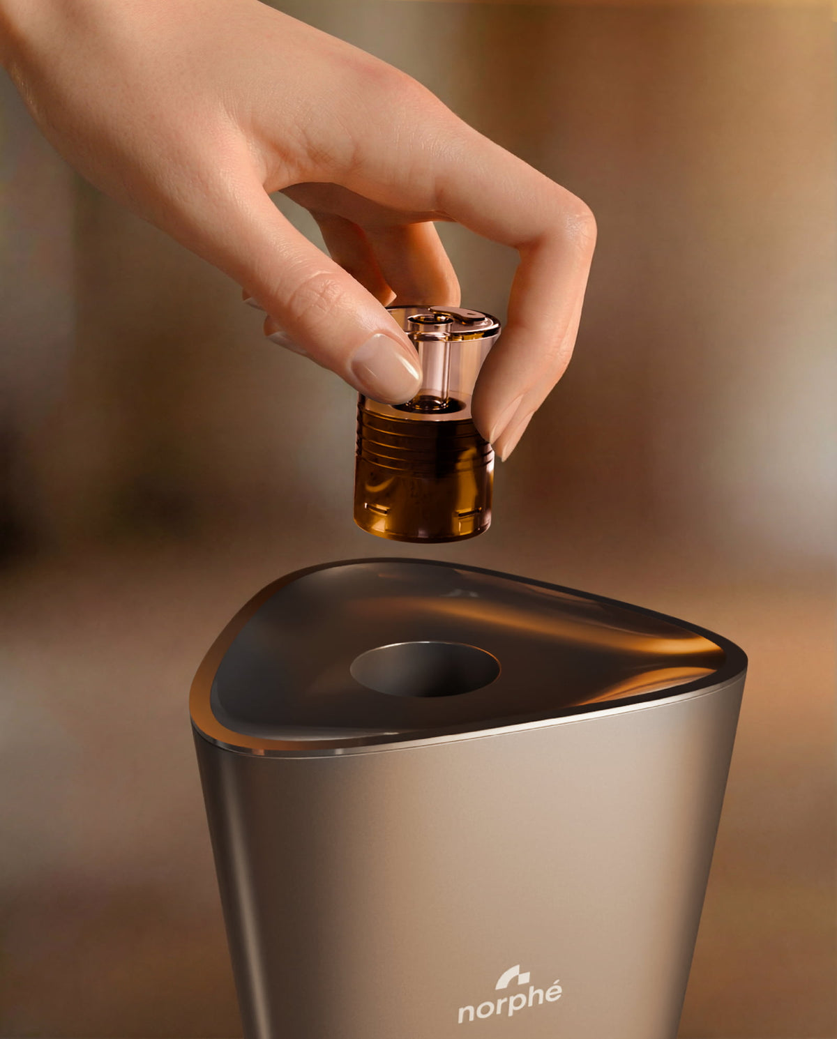 Hand inserting a pod into the Champagne Norphé M1 electronic hookah